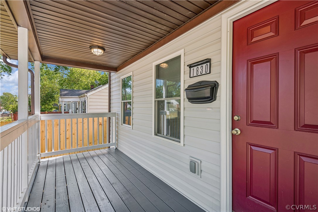 Property entrance featuring a wooden deck