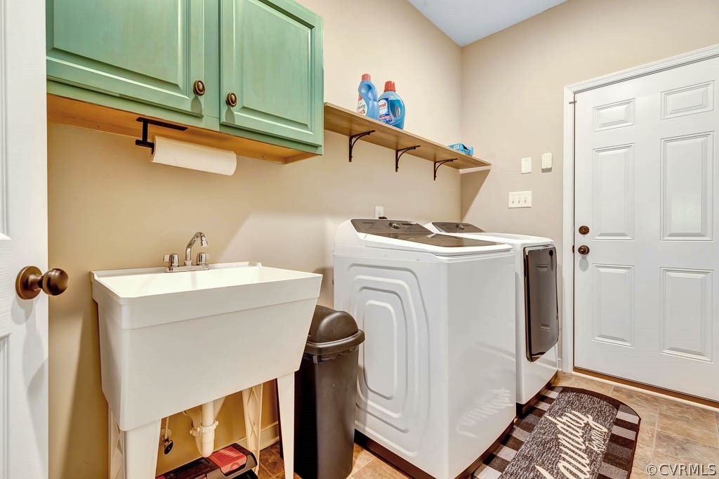Large Laundry Room with utility sink and built in cabinets