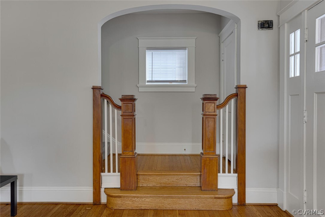 Stairway featuring plenty of natural light and hardwood / wood-style floors