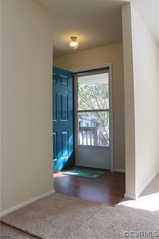 Doorway to outside with wood-type flooring