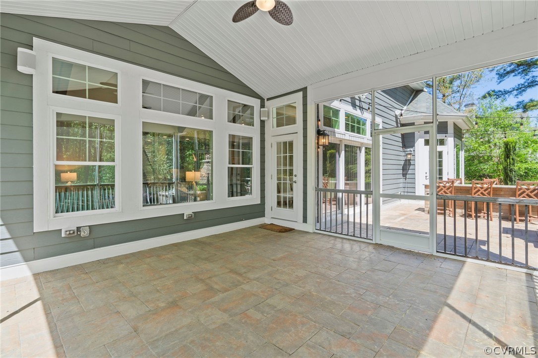Oversized, vaulted ceiling screened in porch with paver flooring. Measuring approximately 17x16'6