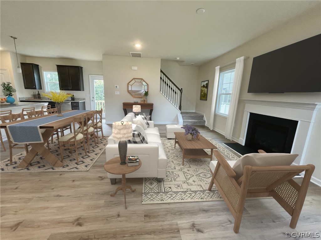 Living room with light hardwood / wood-style flooring