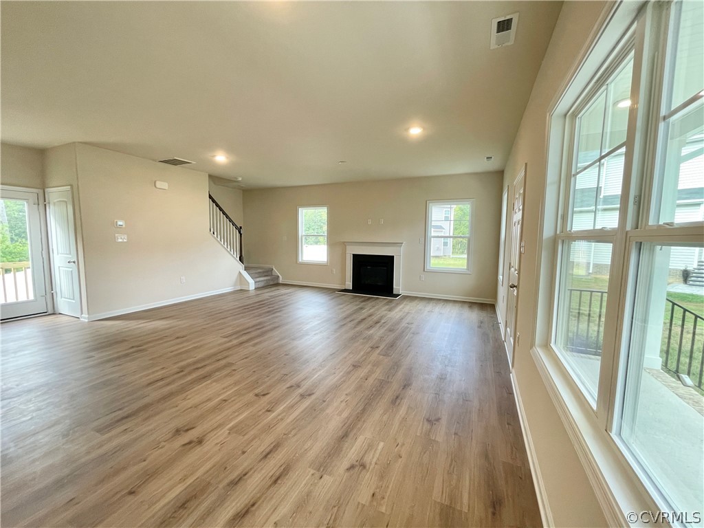 Unfurnished living room with hardwood / wood-style flooring