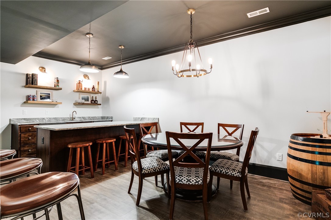 Poker, anyone? The bar features cabinetry, an SS dishwasher, a beverage fridge, and sophisticated charm.