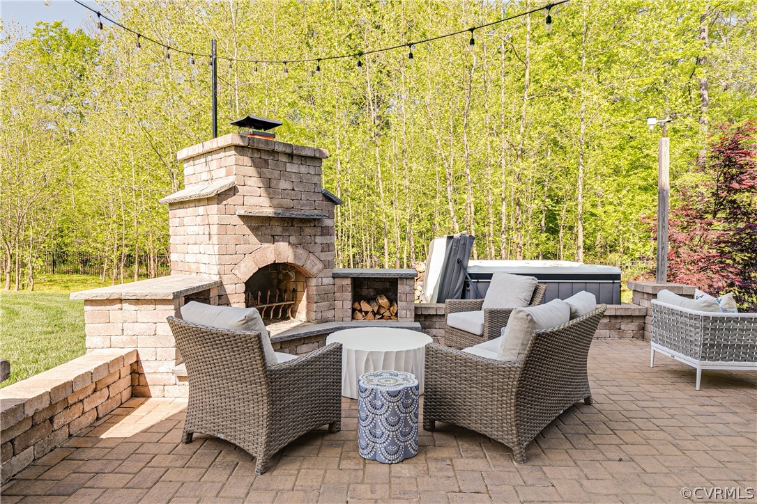 Just in time for summer is your outdoor entertainment center with a stone fireplace ready for your s'mores!