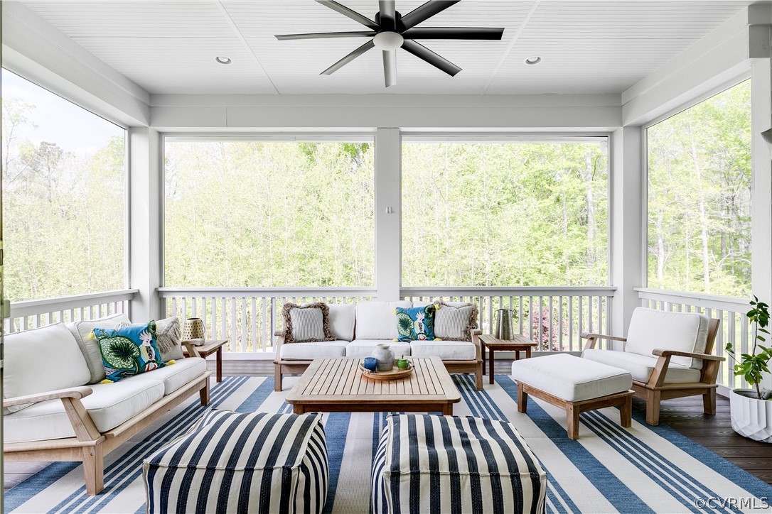 Double sliding doors lead to the huge screened-in porch with a ceiling fan.