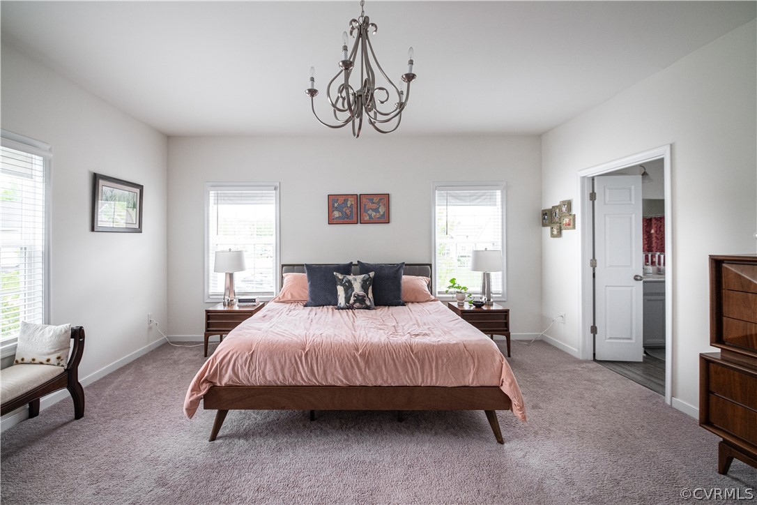 Bedroom featuring carpet flooring and a notable chandelier