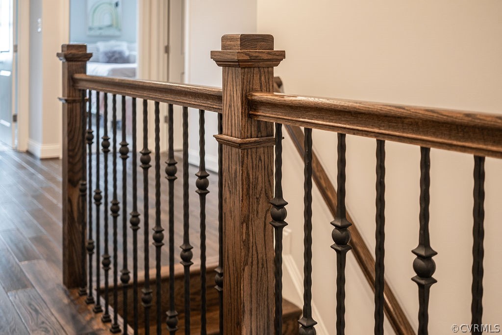 Staircase featuring dark hardwood flooring throughout 2nd level hallways and loft space