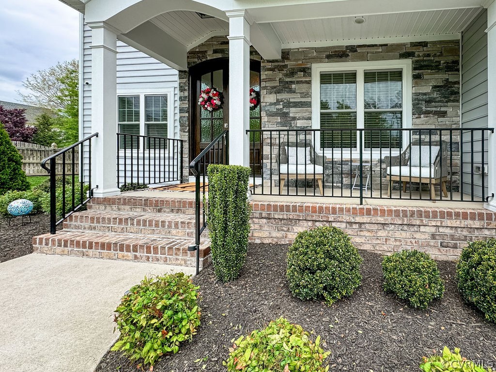Entrance to property featuring covered porch