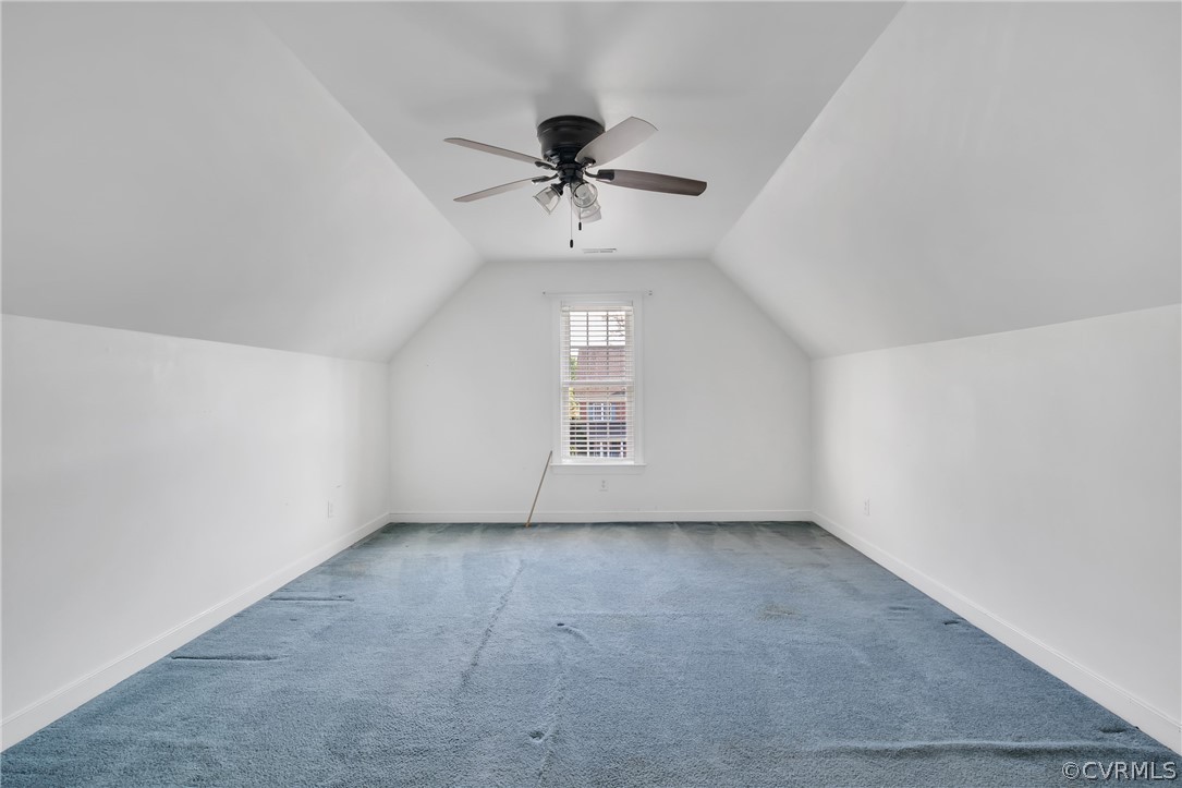 Bonus room with carpet, ceiling fan, and lofted ceiling