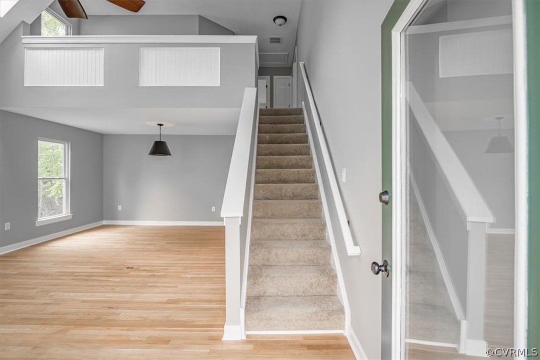 Stairway featuring light hardwood / wood-style flooring and ceiling fan