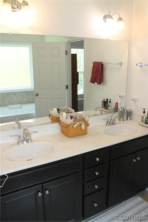 Bathroom with dual bowl vanity and a bath
