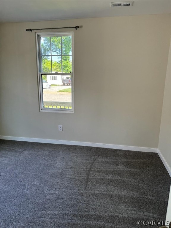 Unfurnished room with plenty of natural light and carpet floors