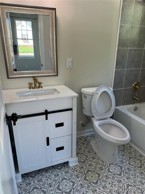 Full bathroom with tile floors, vanity, shower / bathtub combination, and toilet