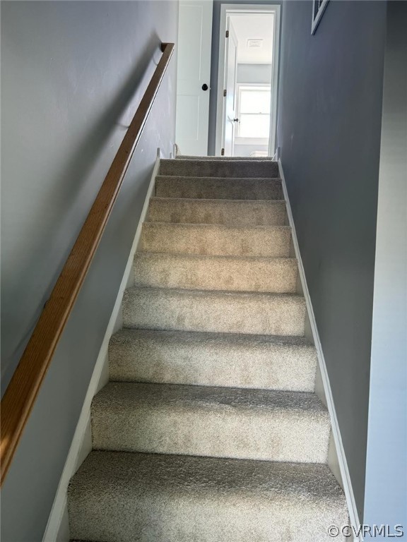 Stairs featuring carpet floors