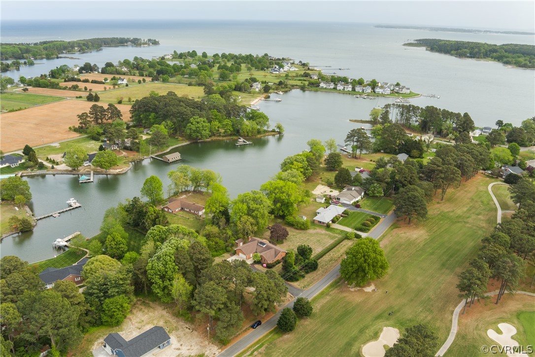 Bird's eye view featuring waterfront view and golf course