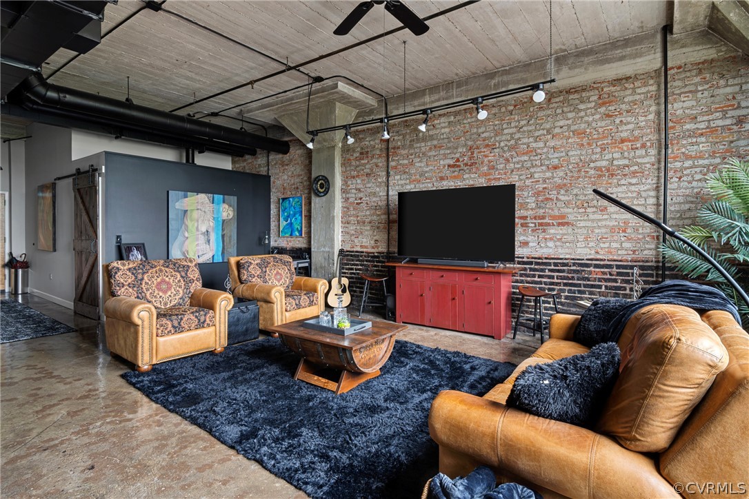 Living room with brick wall and concrete floors