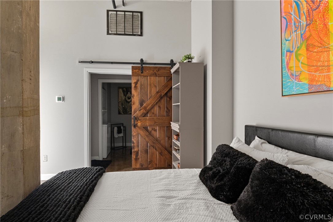 Bedroom featuring dark hardwood barn style door