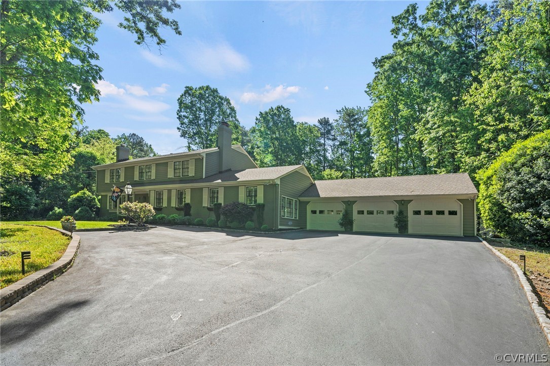 Rare opportunity on Cherokee Rd with heated gunite pool and 3+ car garage! This incredible estate has been home to the original family since construction, and is now being offered for purchase. Elevated on a desirable 1-acre lot in Huguenot Farms, this home is a true blend of timeless charm and modern amenities. Following the slate walkway to the double front doors and covered front porch, you will instantly notice the detail in every inch of this home. The dental molding, smooth symmetry, and central entrance speak to its true Colonial style. The grande entryway opens to the formal living room w crown molding, recessed lights, & gas fireplace, and continues to office w dbl patio doors overlooking the pool. Chef's kitchen offers 6-burner Wolf gas stove, granite countertops, custom backsplash, & breakfast area w built-in seating. Formal dining room includes beamed ceiling, grande fireplace, crown molding, & built-ins. Sunroom w vaulted ceiling offers wet bar, ice maker, wine fridge, bar seating, & dual exits to deck/patio. Spacious family room/rec room is 26x24 with 12ft+ ceilings and walks out to covered patio area with open columns & hardscape. Primary bedroom w crown molding includes private suite w dbl vanity, large walk-in closet, & tile shower. Three additional bedrooms are all generous size w dbl door closets & excellent natural light. Hardwood floors and plantation shutters continue throughout both levels of this home. The back yard is a true private oasis with multiple areas to relax and entertain, including a large composite deck, professional landscaping, fieldstone garden walls, & a concrete apron surrounding the pool. Attached 3+ car garage is over 875 sqft and offers ample storage and workshop space while maintaining plenty of room for your favorite vehicles. The definition of curb appeal, this home includes a brick entryway pillar, stone retaining walls, front/rear irrigation, & paver-lined asphalt drive. Whole-house gas generator is wired & conveys with the sale. This home truly has it all!