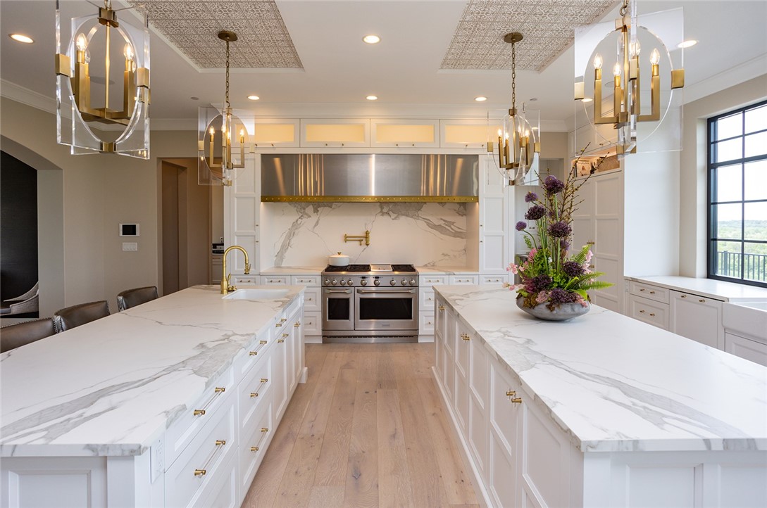 ...to the commercial gas range, custom stainless steel hood and brushed gold pot-filler, every chef (professional or not) will feel at home!