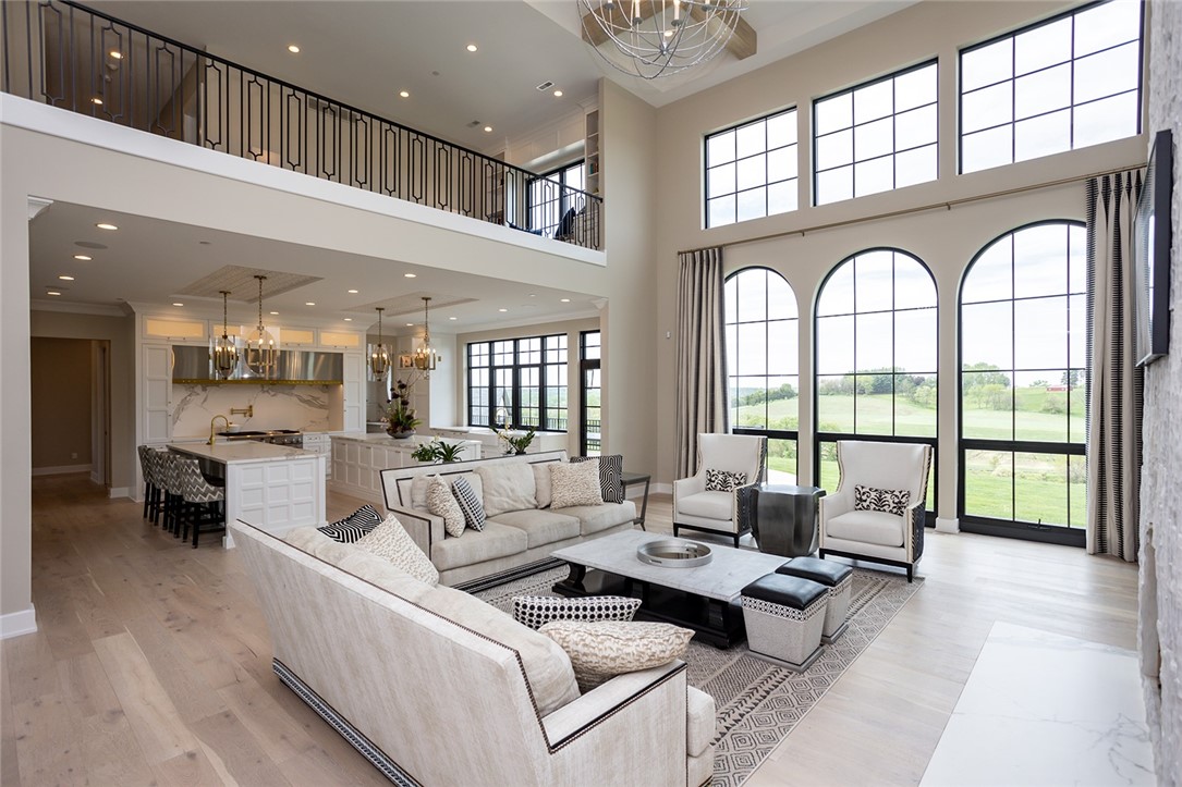 Wood beams flank the ceiling of the 2 story great room, arched windows provide for a picturesque view!
