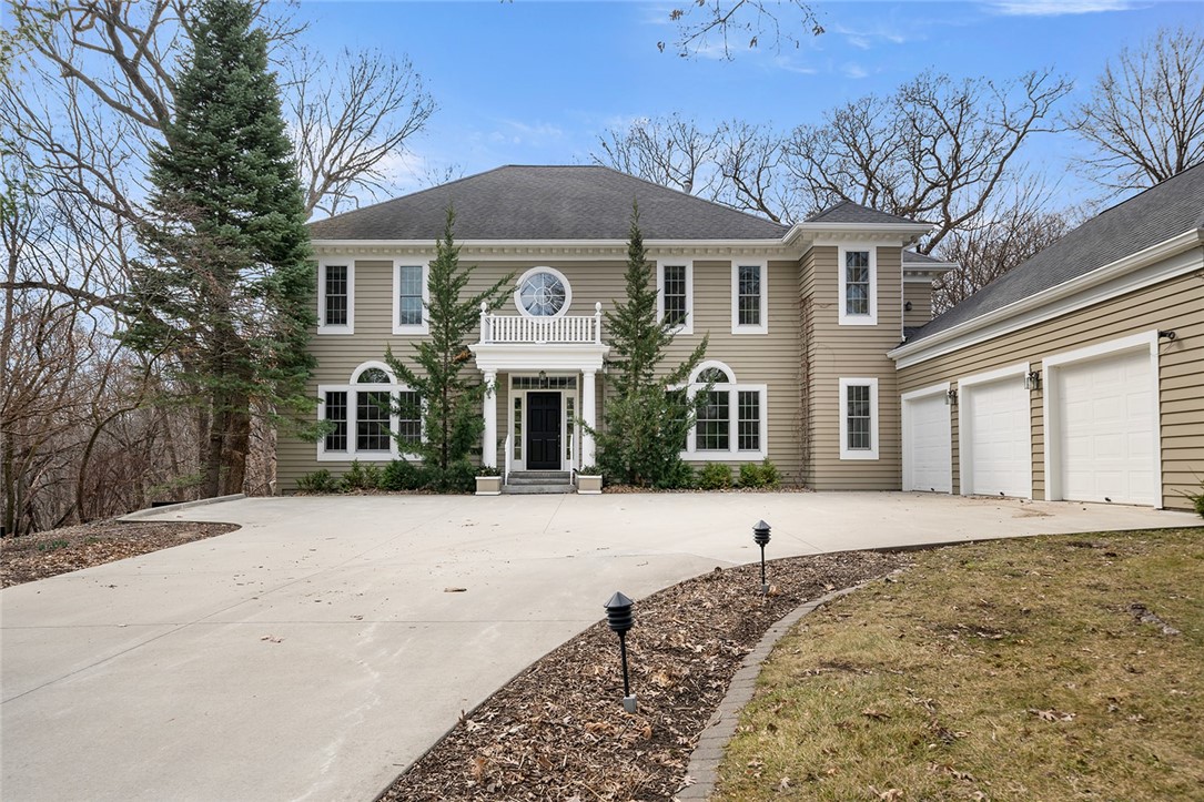 Traditional beauty with 3 car garage and flat driveway.