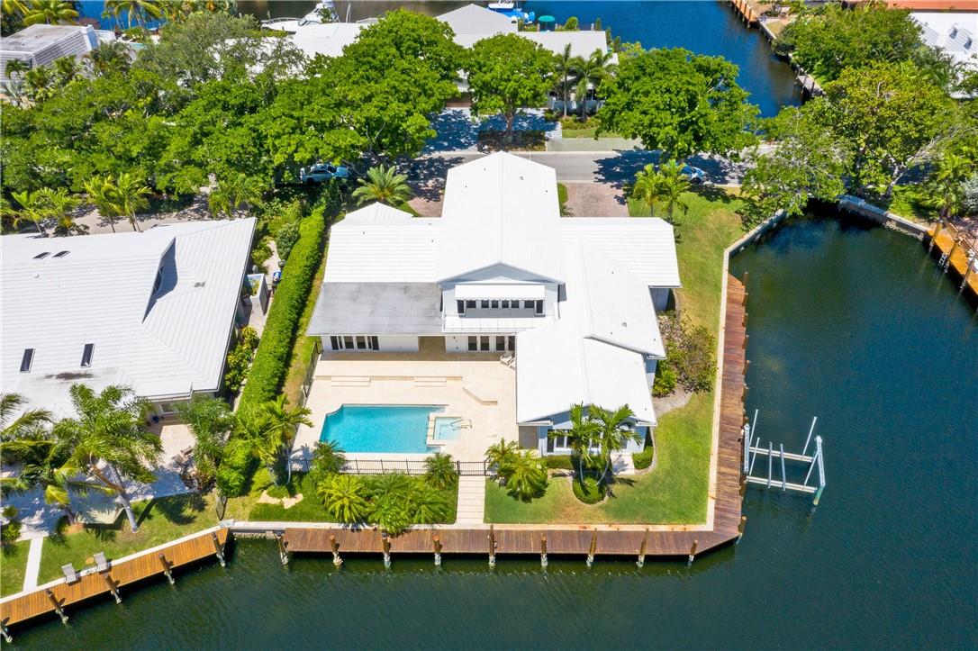 EXCITING NEW LISTING IN THE UPSCALE  BAY COLONY  COMMUNITY OFFERS THIS  RARE TWO-STORY GEORGIAN-STYLE COLONIAL RESIDENCE ON A PRIVATE CORNER LOT WITH  SCENIC 180'  WATERFRONT VIEWS.  THIS LUSHLY LANDSCAPTED POINT LOT HAS INCREDIBLE VIEWS FROM EVERY ROOM.   BRAND NEW  DOCK AROUND THE POINT LOT, A BOATER'S PARADISE. THIS EQUISITELY DESIGNED HOME IS DECORATED  TO PERFECTION AND POSSESSES CHARMING AND EXQUISITE DETAILS THROUGHOUT.  THE MASTER SUITE  COVERS THE WHOLE 2ND  FLOOR WITH HIS AND HER MASTER BATHROOMS.   FRENCH DOORS OPEN ONTO A BALCONY WITH  BREATHTAKING INFINITY VIEWS OF THE  WATERWAY.   A RARE FIND  WITH TROPICAL  LIVE OAK TREES SURROUNDING THE ENTIRE COMMUNITY  OF ULTRA UPSCALE HOMES.  ONCE INSIDE THIS METICULOUSLY DESIGNED RESIDENCE, YOU'LL NEVERF WANT TO LEAVE!