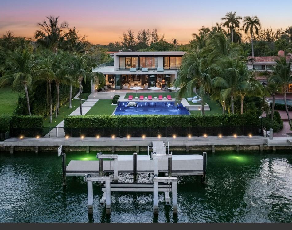 A zen inspired waterfront oasis residing on nearly an acre of land, 36,000sf. Total sf of 11,985sf with lots of outdoor leisure spaces. Private gate, security guard house, and 100ft of ocean access, all in the heart of Miami Beach. Koi ponds and orchid gardens, this 7 bedrooms, 8.4 baths, 4-car garage home has it's very own separate wellness spa with gym, steam/sauna, massage room, surrounded by lush gardens and manicured turf. Natural marble, ipe walls, and white oak floors throughout. Floor to ceiling glass inviting in lots of natural light. Grand living room, Gourmet kitchen with privacy partition walls. Stunning oversized primary suite. State-of-the-art tiled pool & spa, Ferrari red summer kitchen.