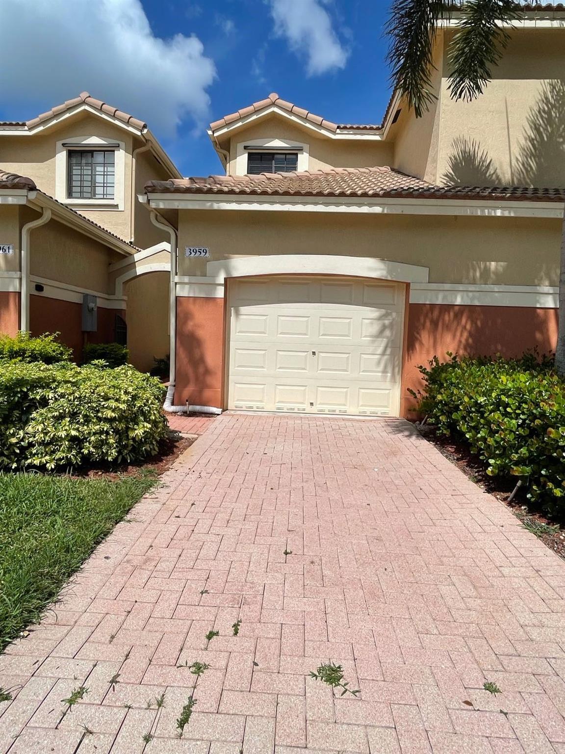 Beautiful spacious townhouse in a gated community with guard on site. Close proximity to highway. Within walking distance of Cypress Bay High School, and Library. Other great schools in the area are Manatee Bay Elementary School and Falcon Cove Middle School. House has a spacious covered patio with garden view.  Attached one car garage plus driveway to fit another car.  Guest parking available. Amenities include community pool and children's playground.  Property has been remodeled including brand new kitchen and laminate floors.