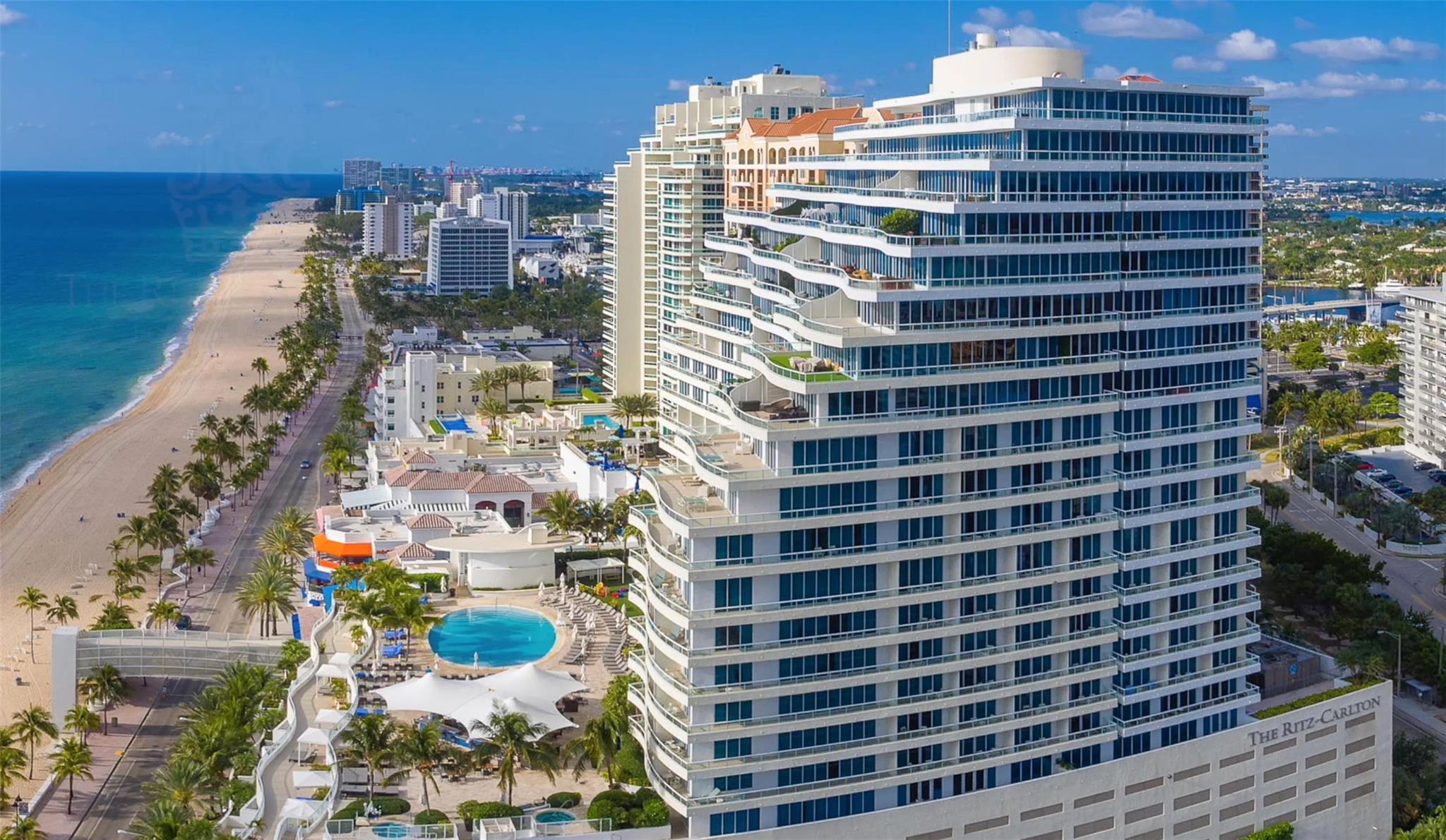 Perched high atop the 5 star Fort Lauderdale Beach Ritz-Carlton Private Residences. This stunning corner 2 bedroom with den/2.5 bathroom residence offers incredible Ocean to Intracoastal views from every room. Primary suite has private terrace access, large walk in closets, primary bath retreat representative of a luxury resort. Motorized solar shades throughout. Walk in utility room with full size washer/dryer. Den easily converts to third sleeping area with pull out sofa. Enjoy The Ritz-Carlton resort lifestyle with a 10,000 sq ft Spa, state-of-the-art fitness center, valet, bell service, in-room dining and two restaurants and bars on property. Tropical pool terrace suspended over the Atlantic Ocean.