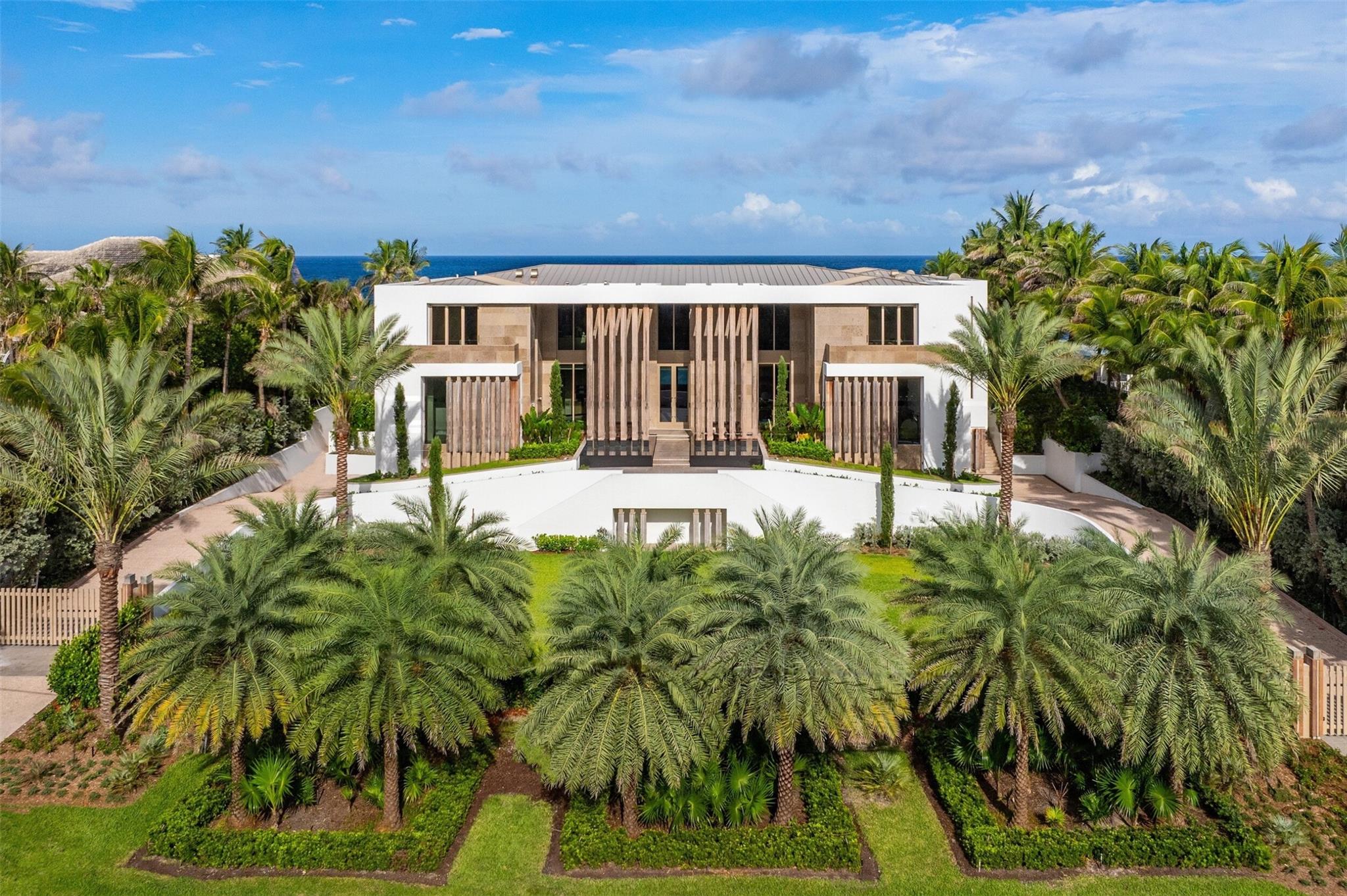 Commanding a premier Oceanfront 1.5-acre parcel, this magnificently scaled Modern Masterpiece spans 172ft on the Atlantic & 172ft on the Intracoastal w/a 50-ft dock. A minimalist aesthetic & natural materials define the monumental, newly constructed 3-story marvel. Soaring dbl-height Entry framed by dramatic waterfalls opens to dbl-height Foyer w/sweeping ocean views. Full slab Limestone & wide-plank Oak floors set the stage; exterior glass walls & Nano doors invite abundant light. A dedicated oceanfront Wellness wing, 2 Pools (indoor & outdoor), Primary suites on 2 levels, Entertaining & Chef’s production Kitchens, Lutron & Sonos systems, extensive Staff Qtrs & 16-car ground-flr Parking give new meaning to true luxury. An incomparable Estate designed for the world’s most discerning buyer. Magnificently scaled Florida Modern 3-flr Masterpiece spans Atlantic & Intracoastal on 1.5 oceanfront acres in upscale Manalapan along FLA Gold Coast.