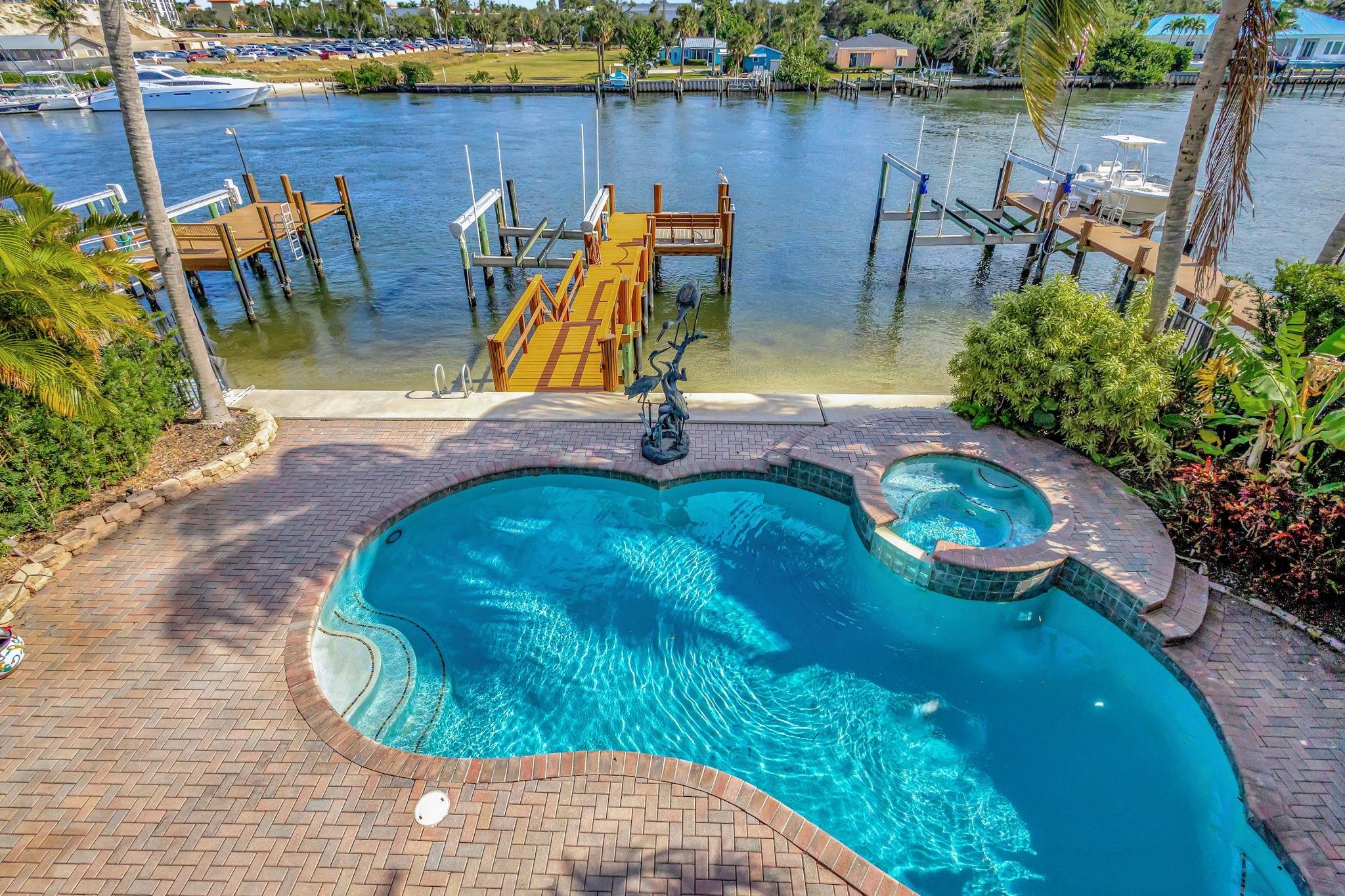 A Rare Opportunity to Experience the ultimate in Waterfront Luxury Intercoastal Living at Prosperity Harbor. This meticulously maintained home is nestled in an exclusive gated community. A boater's paradise with no Fixed Bridges and a once-in-a-lifetime chance to own a true masterpiece.
 The private dock, complete with a 27,000-lb. boat lift, accommodates 2 boats, while the slow-wake zone ensures peace and tranquility all year round.  
Upon entering, be welcomed by an abundance of natural light, a seamless blend of elegance and beauty. The heart of the home centers around the panoramic water views and an expansive, open floor plan, making it an ideal setting for entertaining or serene relaxation. Designed to exceed all expectations.
Inside, no detail has been​​‌​​​​‌​​‌‌​‌‌‌​​‌‌​‌‌‌​​‌‌​‌‌‌ spared.