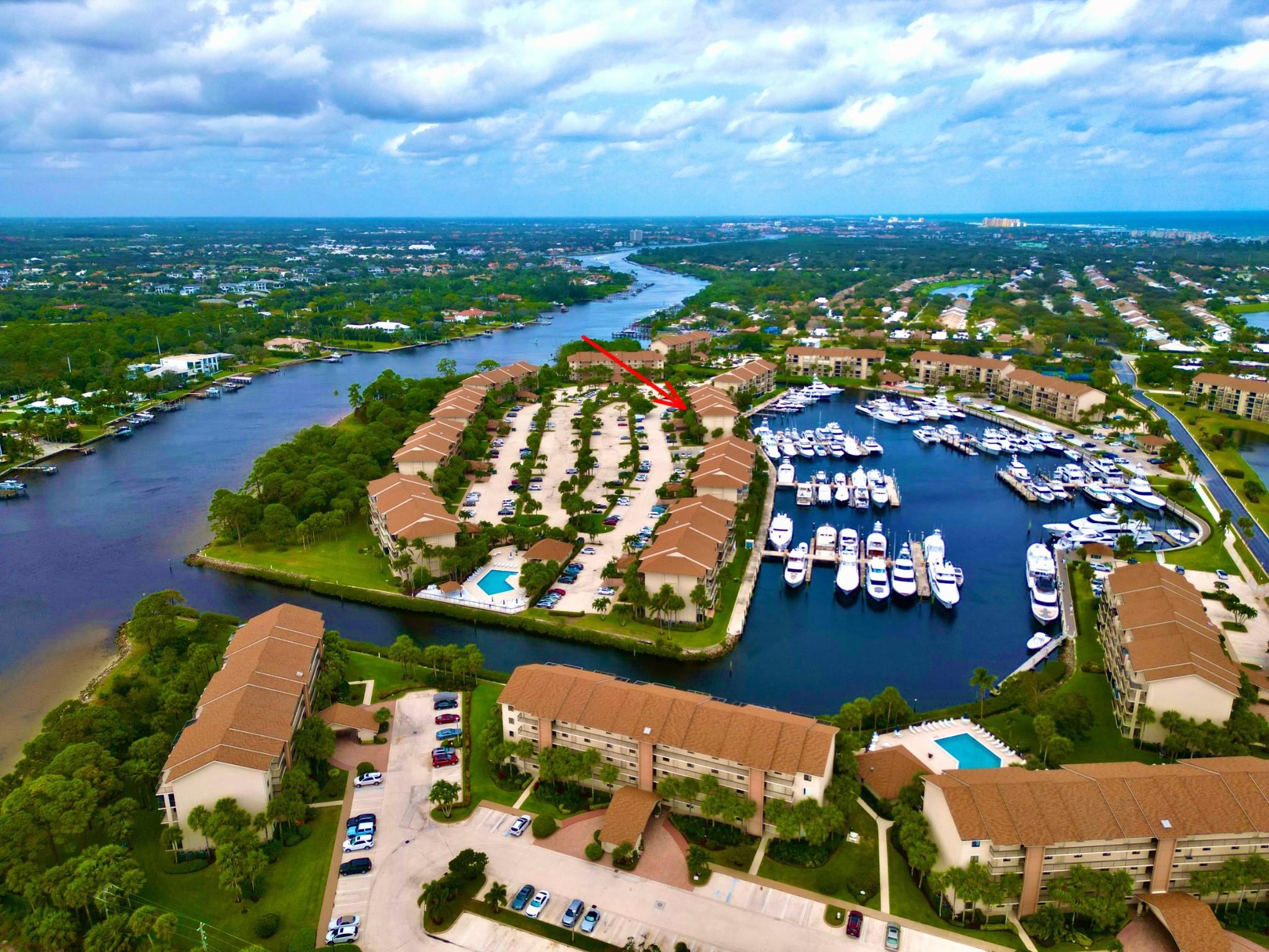 Discover this elegantly renovated two-bedroom, two-bathroom condo with an office, situated on Marina Isle Way's first floor. Relish stunning marina views from your screened patio. The living space is perfect for entertaining, featuring a newly updated kitchen with quartz countertops, shaker cabinets, and stainless steel appliances. Luxuriously updated bathrooms showcase walk-in showers and high-end finishes. Flooring combines Italian tile with Brazilian cherry wood, accented by recessed lighting. A new laundry room includes California cabinetry and additional office space. Residents enjoy access to four heated pools and well-maintained tennis courts.