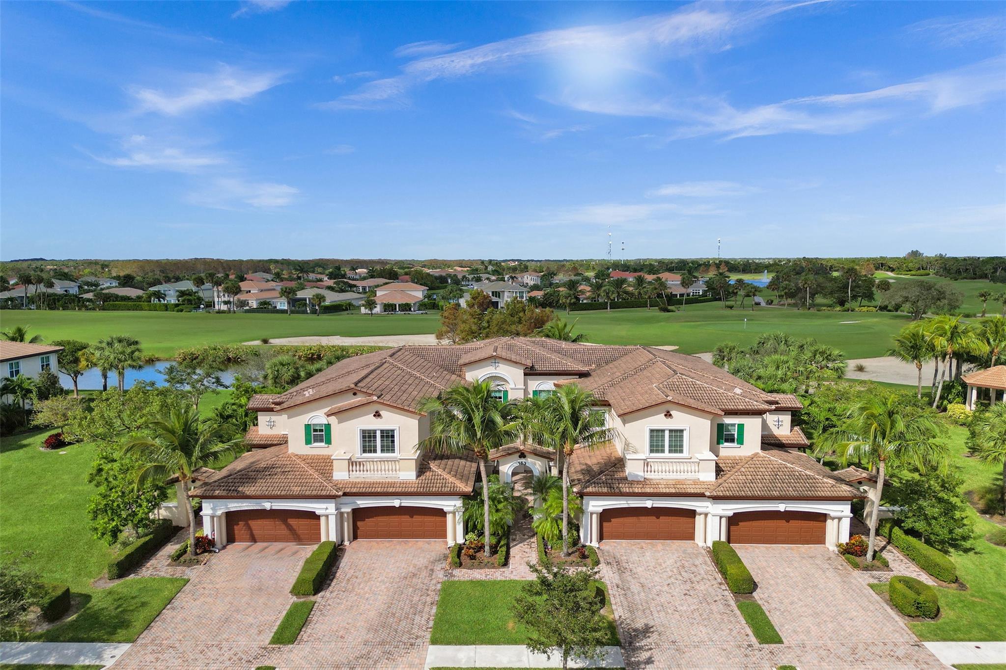 Discover luxury living at its finest in this exquisite ground-floor 2 bed, 2 bath + den condo, nestled in prestigious Jupiter CC! This stunning corner unit, triple split plan offers panoramic lake & golf course views from every room! Modern, open-concept kitchen w/ granite, tumbled tile backsplash, extended cooking island & breakfast nook! Entertain effortlessly in spacious living/dining areas overlooking oversized screened-in patio w/ amazing views. Upgrades incl. automated shades, crown molding, tray ceilings & recessed lighting! Impact glass thru/out, sep. laundry rm & 2-car garage! This unit includes coveted GOLF & SOCIAL memberships w/ access to exclusive amenities incl. championship golf course, tennis courts, fitness center, spa, fine dining restaurant & more! A true must see!