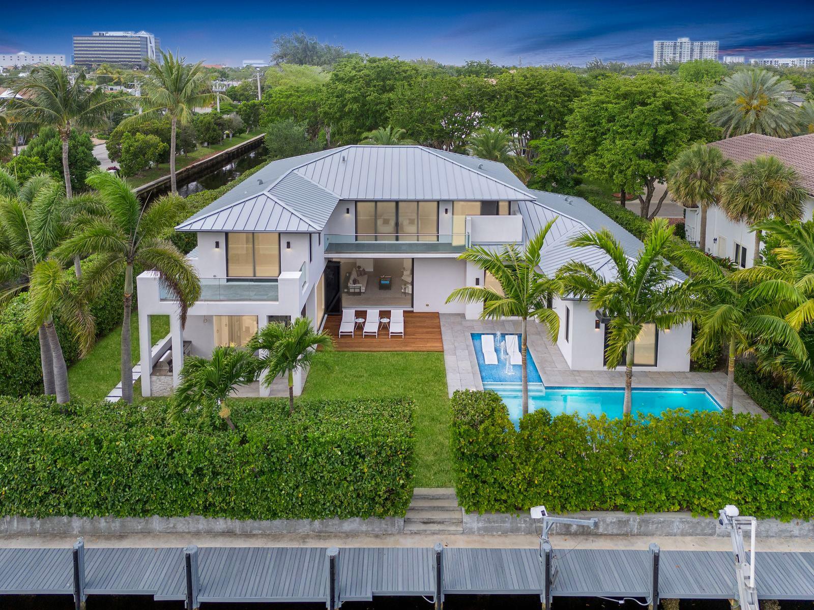 Own this elite newly constructed waterfront estate in BAY COLONY completed in 2023, offering ultimate elegance in Fort Lauderdale’s most prestigious gated community. Featuring a modern gourmet kitchen, home theater & private office. Living spaces are filled with natural light due to the South facing design. With unique details such as collapsing nano doors leading to the summer kitchen, entertaining spaces seamlessly flow from inside to outdoors. Nestled on an interior-facing point lot with 310ft of water frontage, ideal for multiple vessels.  The garage accommodates up to 6 cars with lifts installed. Conveniently located near Pine Crest School, Coral Ridge CC, executive airport & the beach, this estate emanates an unmatched lifestyle. 24/7 armed security. Seller Financing Available.