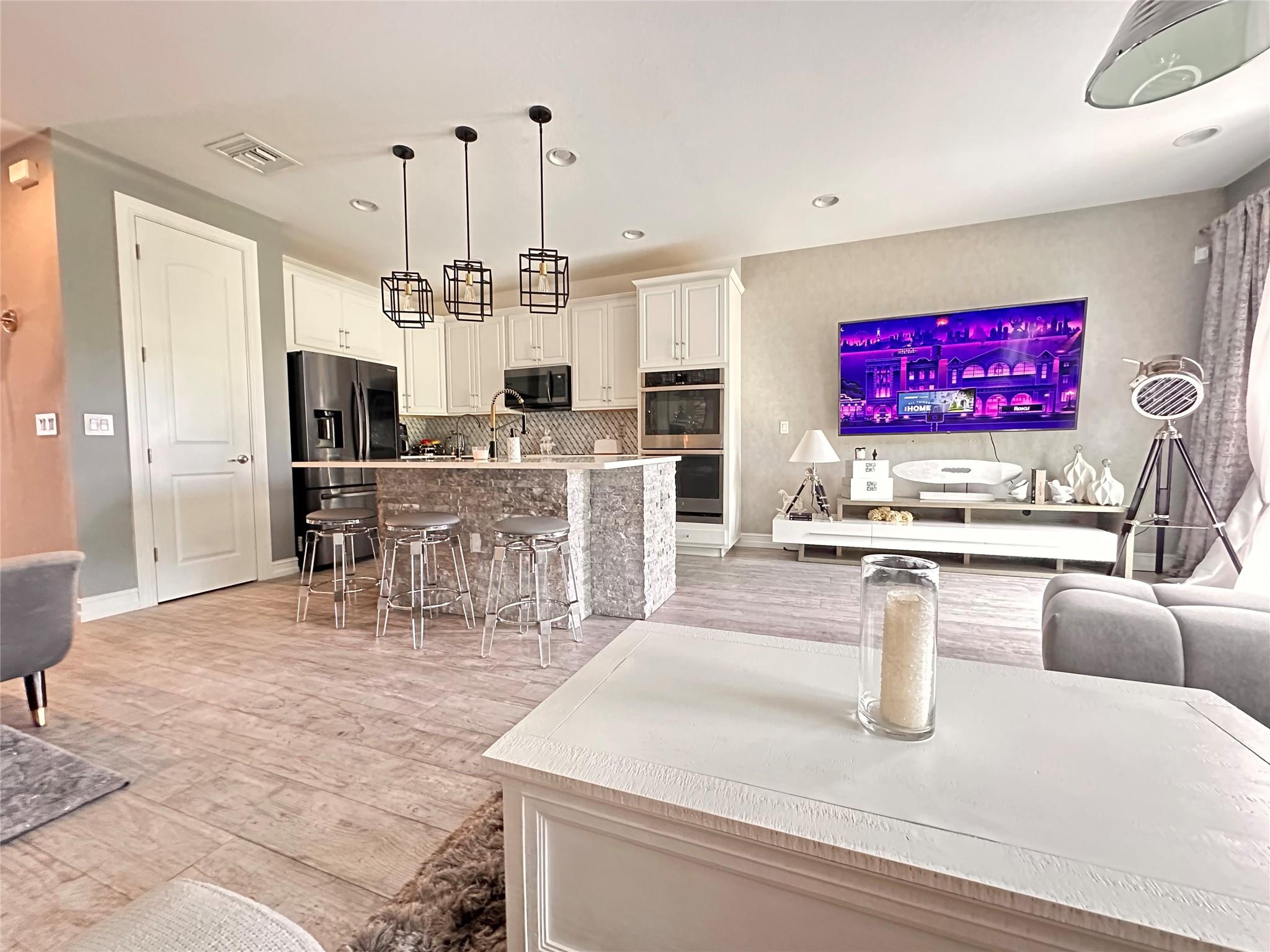 Spectacular, one-of-a-kind townhome in the highly desirable Enclave Boca Dunes community. Custom details and upgrades make this property truly stand out. Bright and cozy, it features stylish wall paneling, beautiful paint colors, window treatments, upgraded appliances, and more.
The seller is including a high-end water filtration system, which will be fully paid off at closing. The back patio overlooks a serene pond and greenery and can be fenced for added privacy. An oversized driveway allows one to park up to 3 cars. Guests can also park on the streets. 
The low maintenance fee covers roof maintenance, landscaping, and resort-style amenities, and more. Pets and investors friendly. Trucks OK, Motorcycles OK. Furnitures are negotiable in a separate contract. Schedule your showing today! The COMMUNITY OFFERS AWESOME clubhouse, pool, heated spa, fitness center, tot playground, billiards room, and more. You can play golf, membership optional.