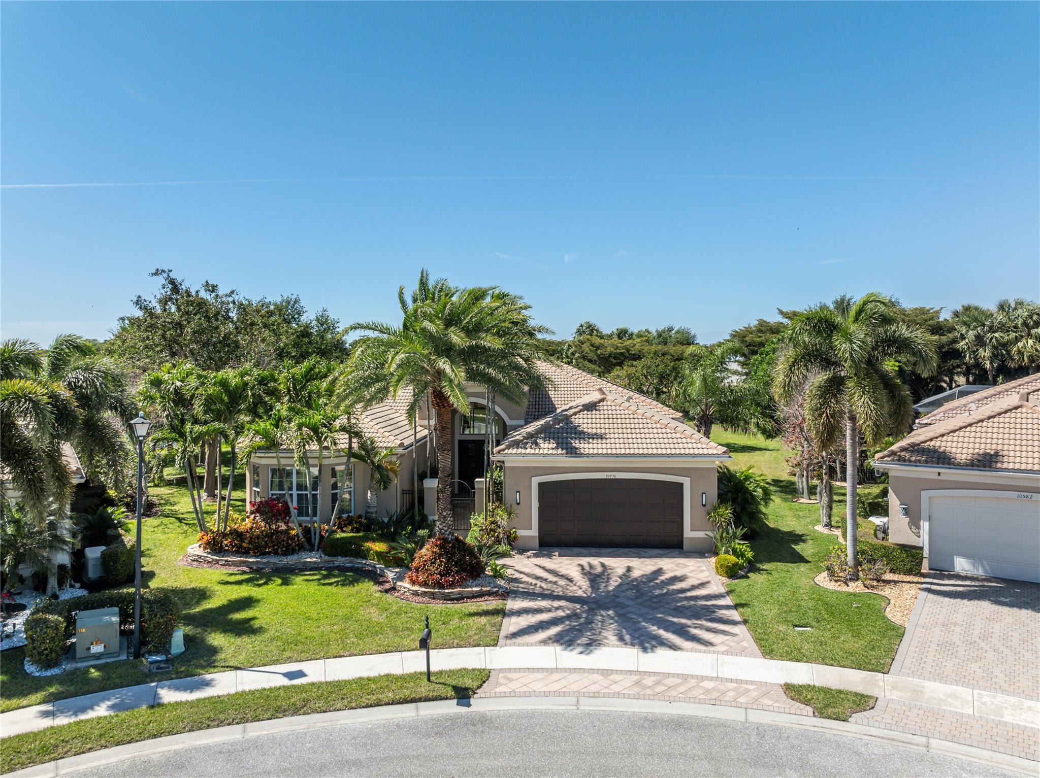 Welcome to 10576 Whitewind Circle, a pristine and meticulously maintained 3BR/2.5BA home located in Valencia Reserve, Boynton Beach' premier active adult community. This incredible Pamplona II model spares no expense and sits on one of the most private lots within this incredible gated community. Located on a recessed cul-de-sac, the light and bright home boasts expansive Owner's Suite, gourmet eat-in kitchen, 24x24 marble floors, solid wood doors, custom built-ins, walk-in closets and decorator touches. The outside impresses with landscape lighting, covered patio and pie-shaped lot providing spectacular sunset views. Enjoy a glass of wine, a cup of coffee or simply read your favorite book. Impact windows, newer AC's, oversized garage and pride of ownership complete this wonderful home. Floorplan attached