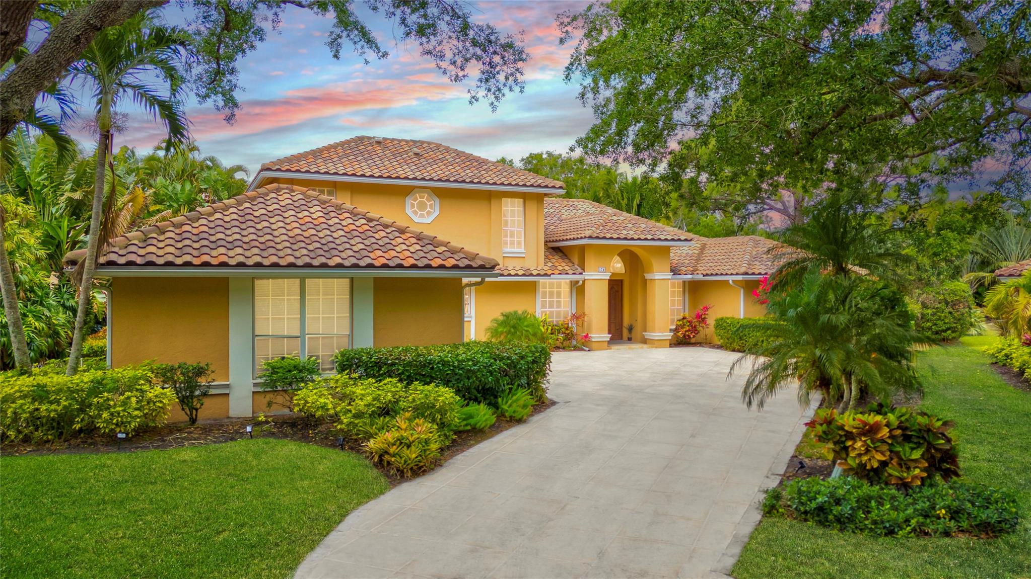 Discover comfort and luxury in this stunning 2-story home, tucked inside a private gated community at the end of a quiet cul-de-sac. Set on over 16,000 sq ft, this 3,600+ sq ft home offers high ceilings, tons of natural light, and peaceful lake views. Enjoy a cozy living room with fireplace and built-in bar, plus a chef’s kitchen with custom wood cabinets, granite counters, and a walk-in pantry. The first-floor primary suite features tray ceilings, dual closets, a spa-like bath, soaking tub, and walk-in shower. Entertain outdoors with a screened kitchen, saltwater pool, and spa. Includes 3-car garage, 2023 AC, and 2015 barrel tile roof. Stay friendly.