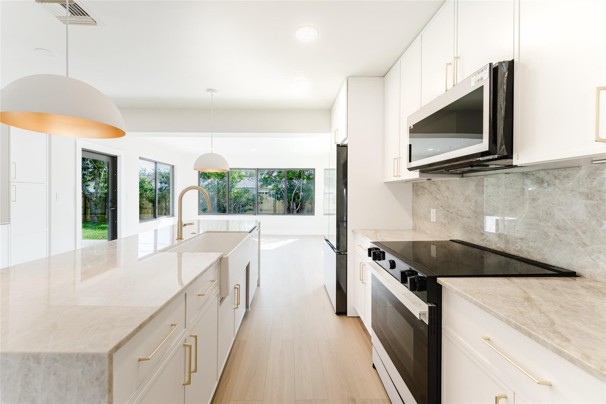 Pristine, fully remodeled home in the desirable Cove neighborhood. Taj Mahal Quartzite from Brazil dresses the kitchen beautifully with waterfall countertops + stunning coffee bar. Bespoke, brand new appliances from Samsung blend seamlessly with the white cabinets + gold hardware. Stunning floors + ample natural light create an airy feel in this spacious home. Hurricane impact windows + doors throughout. Newly resurfaced pool, travertine pavers + wood deck. Natural grass lawn is perfect for kids + pets. 2023 roof! Primary bedroom has a large walk in closet + beautifully remodeled bathroom. Indoor laundry room is perfect for our tropical climate. One car garage with extra storage space. Double gate allows for boat, RV, jet ski or golf cart parking. Walking distance from the beach! Pristine, fully remodeled home in the desirable Cove neighborhood. Taj Mahal Quartzite from Brazil dresses the kitchen beautifully with waterfall countertops + stunning coffee bar. Bespoke, brand new appliances from Samsung blend seamlessly with the white cabinets + gold hardware. Stunning floors + ample natural light create an airy feel in this spacious home. Hurricane impact windows + doors throughout. Newly resurfaced pool, travertine pavers + wood deck. Natural grass lawn is perfect for kids + pets. 2023 roof! Primary bedroom has a large walk in closet + beautifully remodeled bathroom. Indoor laundry room is perfect for our tropical climate. One car garage with extra storage space. Double gate allows for boat, RV, jet ski or golf cart parking. Walking distance from the beach!