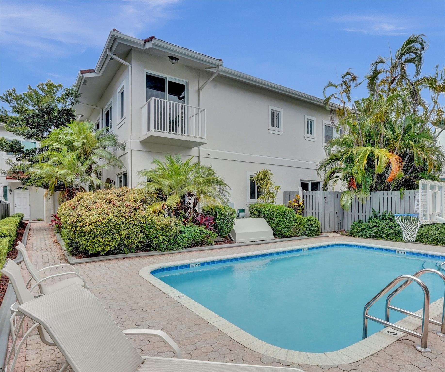 Rare opportunity to own over 1,500 square feet of living space in sought after Victoria Park for under $620k!! Bright and spacious interior corner townhome in gated Villa Victoria. Enjoy three sun-filled exposures, 10’ ceilings, impact windows and doors (2021), updated interiors, newer AC (2022), and many newer appliances. Private gated courtyard entry opens to foyer, sunny breakfast room, and large living/dining area with fireplace. Tropical, low-maintenance backyard is ideal for entertaining. Upstairs features two large ensuite bedrooms with generous closets; the primary offers a balcony overlooking the pool. Pet friendly and perfectly located near Las Olas, beaches, parks, shopping, and dining!