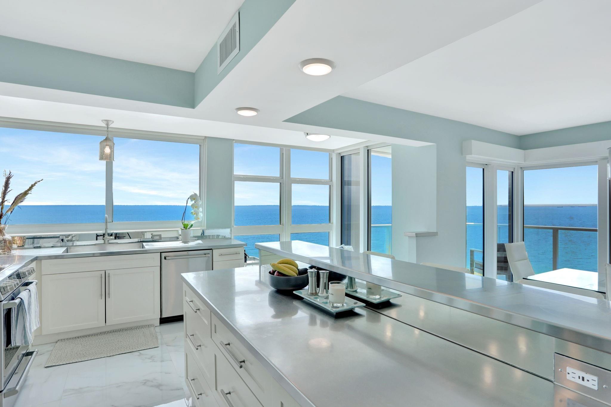 Ocean! Ocean! Ocean views for miles! Rarely Available Southeast Corner Unit with Unobstructed Ocean Views from every corner of the unit. Highly sought-after Southeast corner residence offers breathtaking, panoramic ocean views stretching all the way to Fort Lauderdale. Flooded with natural light and fully renovated with exquisite attention to detail, this unit features oversized tile flooring throughout, sleek electric blinds, all new interior doors and trim, designer lighting fixtures, and elegant seamless glass shower doors. The most amazing sunrises and sunsets. The open-concept kitchen showcases stainless steel countertops and appliances, perfect for entertaining with the amazing ocean views. Nicely designed split-bedroom layout provides privacy and comfort.  The furniture is available Furniture is available.