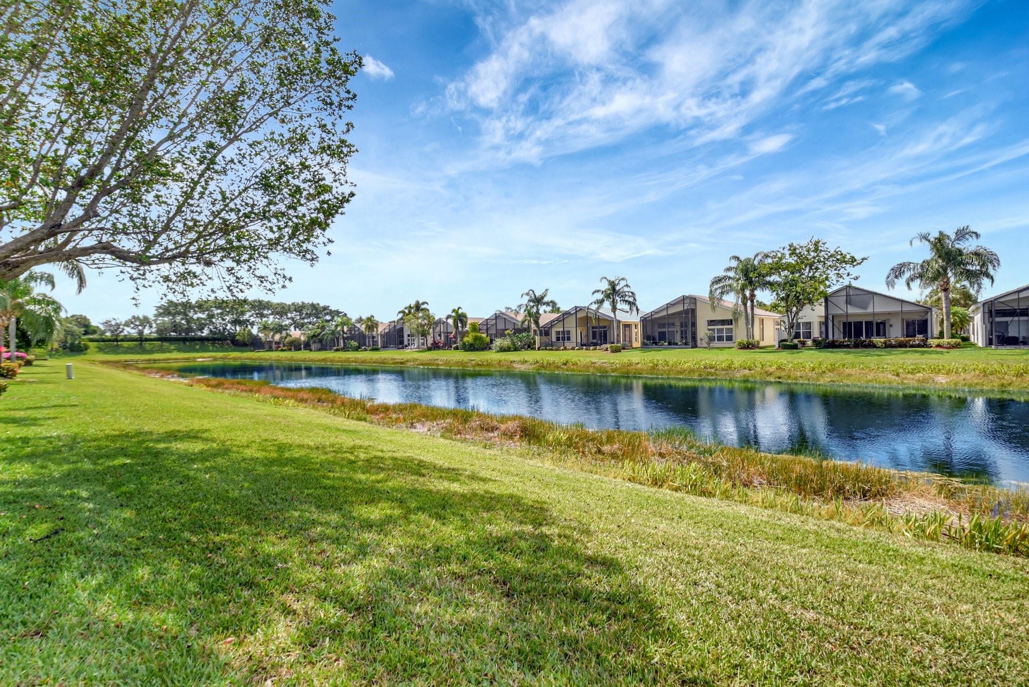 Fall in Love with this BEAUTIFUL Lakefront home! Most desired Atlantic model w/wall down offers the most sought after open-concept layout creating a bright & spacious living area. DREAM KITCHEN features WHITE SOLID WOOD CABINETRY, Quartzite counters*hooded induction cooktop*double ovens*an abundance of storage space*Blending style & function perfectly! 2nd Bath totally remodeled. Extended screened lanai to enjoy the serene southern exposure and South Florida Lifestyle. Accordion Hurricane Shutters-NEW A/C 2023. Being sold turn-key, fully furnished. Fabulous 55+ living at Valencia Shores-The BEST amenities! Social & Athletic Clubs, Cafe, 6 Pickleball, 10 Tennis, 3 Bocce Courts, Fitness Center, Hair & Nail Salon, Social Clubs Galore. Fabulous Entertainment! The Very Best of everything!!