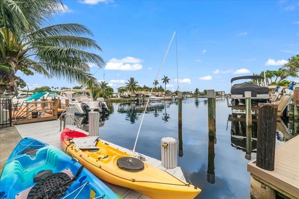 Welcome to a stunning contemporary industrial designed retreat in Pompano Beach. This 3-bedroom, 3-bath home spans 2797 SF of luxurious living space. Each oversized bedroom offers versatile spaces for sitting or office areas, and includes custom closets for optimal storage. Modern comforts are ensured with a new metal roof, A/C, hot water heater, and a comprehensive alarm system with cameras. Enjoy the large backyard with a pool, patio and boat dock, that is perfect for entertainment. A unique walled walkway leads to a convenient laundry/storage room and a playful putting green. Embrace a seamless blend of elegance and functionality in this exquisite canal-front home.