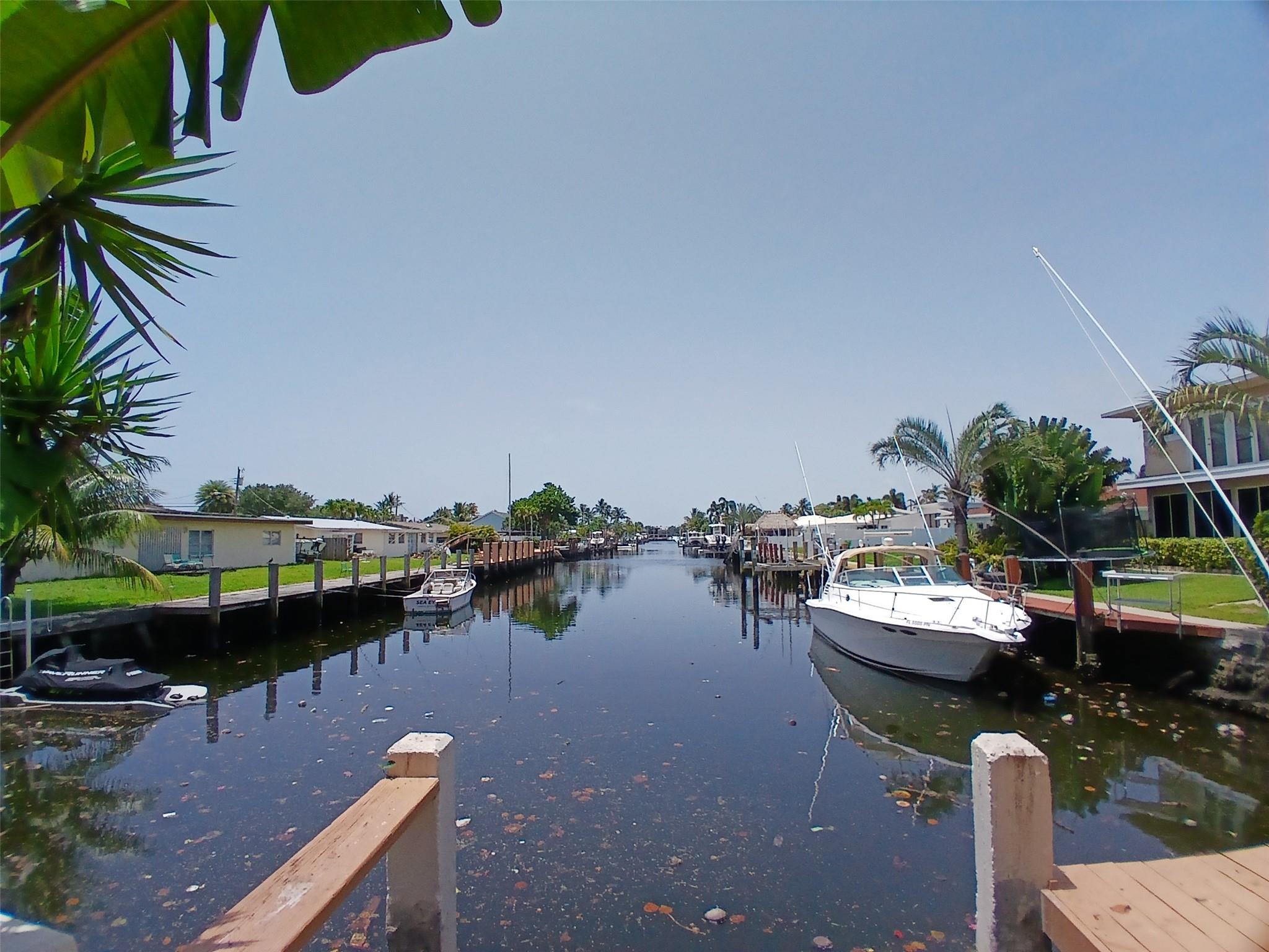 OCEAN ACCESS and LONG VIEW of Canal from this Amazing Home! Short Ride to the Ocean or Intracoastal. Excellent Potential for Customization due to Versatile 2 Story Layout and Room Placement Options. Many Possibilities to Make this Waterfront Home Your Own. Currently the Residence has 2 Kitchens- Upstairs and Downstairs. Upstairs has 2 Large Bedrooms with Possibility of a 3rd and is also Handicap Accessible with Lift. Downstairs is Currently an Open Concept Cabana Style Layout with Bath and Kitchen. AC Units are 2018 and 2022. Tankless WH, Updated Electrical Panels and Custom Oak Doors and Garage Doors. The Roof is believed to be in Good Condition, Maintenance is done Annually. Pavers in the Rear Pool area and Front Driveway. Plenty of Parking. The Home is Priced Right for a Quick Sale. Excellent Value with Many Possibilities with this OCEAN ACCESS WATERFRONT HOME!