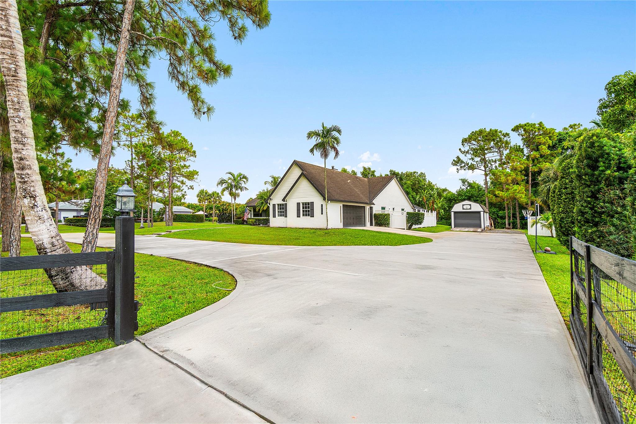 CITY WATER! Beautifully updated 4-bedroom home with a den (can be 5th bedroom), 2.5 baths, remodeled kitchen with massive island, great storage, and appliances under 2 years old. Premium vinyl floors, fresh paint inside and out, new A/C, updated fireplace, washer/dryer included. Most windows are hurricane-proof (all bedrooms and baths). Screened front porch, private screened pool with large covered patio. Huge fenced lot with 2 gated entrances, including 1 automatic gate for added security. Parking for 10+ cars, 2 RV hookups, 2 sheds, large attic. No HOA! Rare CITY WATER—less than 10% of homes in the area have it. Must see!