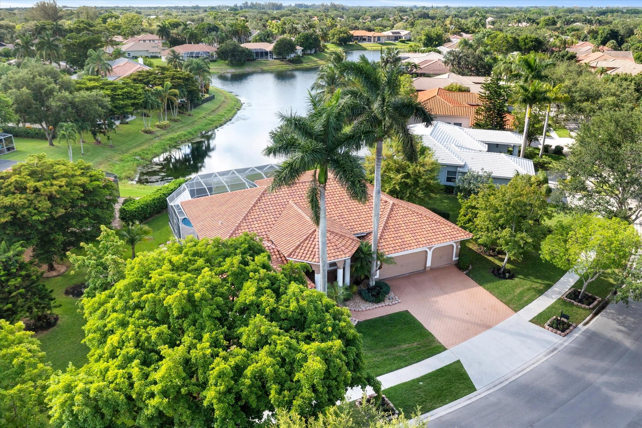 Completely reimagined & impeccably renovated with the finest materials. A sophisticated, contemporary oasis tailored for Florida’s seamless indoor/outdoor lifestyle. Walls of impact windows & doors flood the space with natural light & offer stunning views of the pool & lake. At the heart of the home, a show-stopping white kitchen takes center stage, featuring a dramatic waterfall island, quartz counters, top-of-the-line appliances & a striking glass tile backsplash. The Primary suite is impressive in size & boasts a spa like bathroom, several large closets with cabinetry & serene water views. Outside is an expansive screened porch with a heated saltwater pool with a spa & full service summer kitchen. Other offerings: Wood Like tile thruout, gorgeous lighting, Tesla charging station & more.