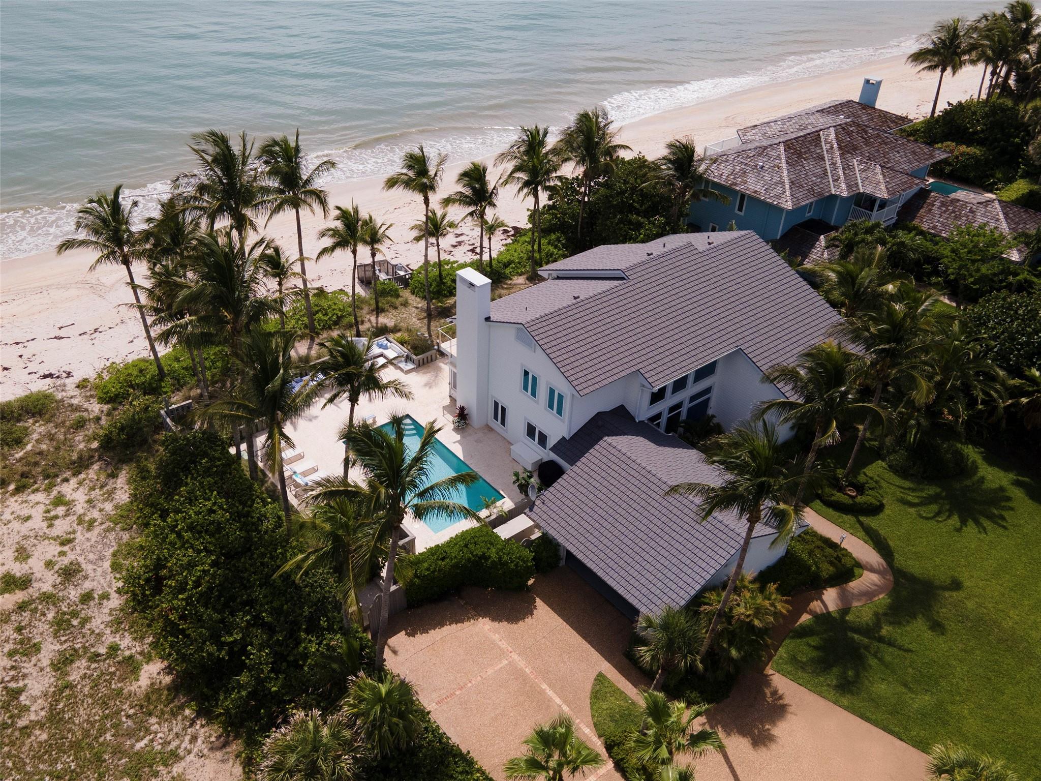 Turnkey oceanfront estate in the prestigious guard-gated community of Seagrove. Renovated by Croom Construction in 2012 with lifetime raised aluminum roof, impact glass, and electric storm shutters. Featuring 120 ft of private beachfront, floor-to-ceiling windows, and an open concept layout ideal for entertaining. Two elegant primary suites and sunlit living spaces create a seamless indoor-outdoor flow. Minutes from Vero’s upscale dining, boutique shopping, and cultural venues. A rare opportunity to own a refined coastal retreat in one of Vero Beach’s most sought-after enclaves. Move-in ready and meticulously maintained, with lush tropical landscaping, generous outdoor living spaces, and timeless architectural charm.
