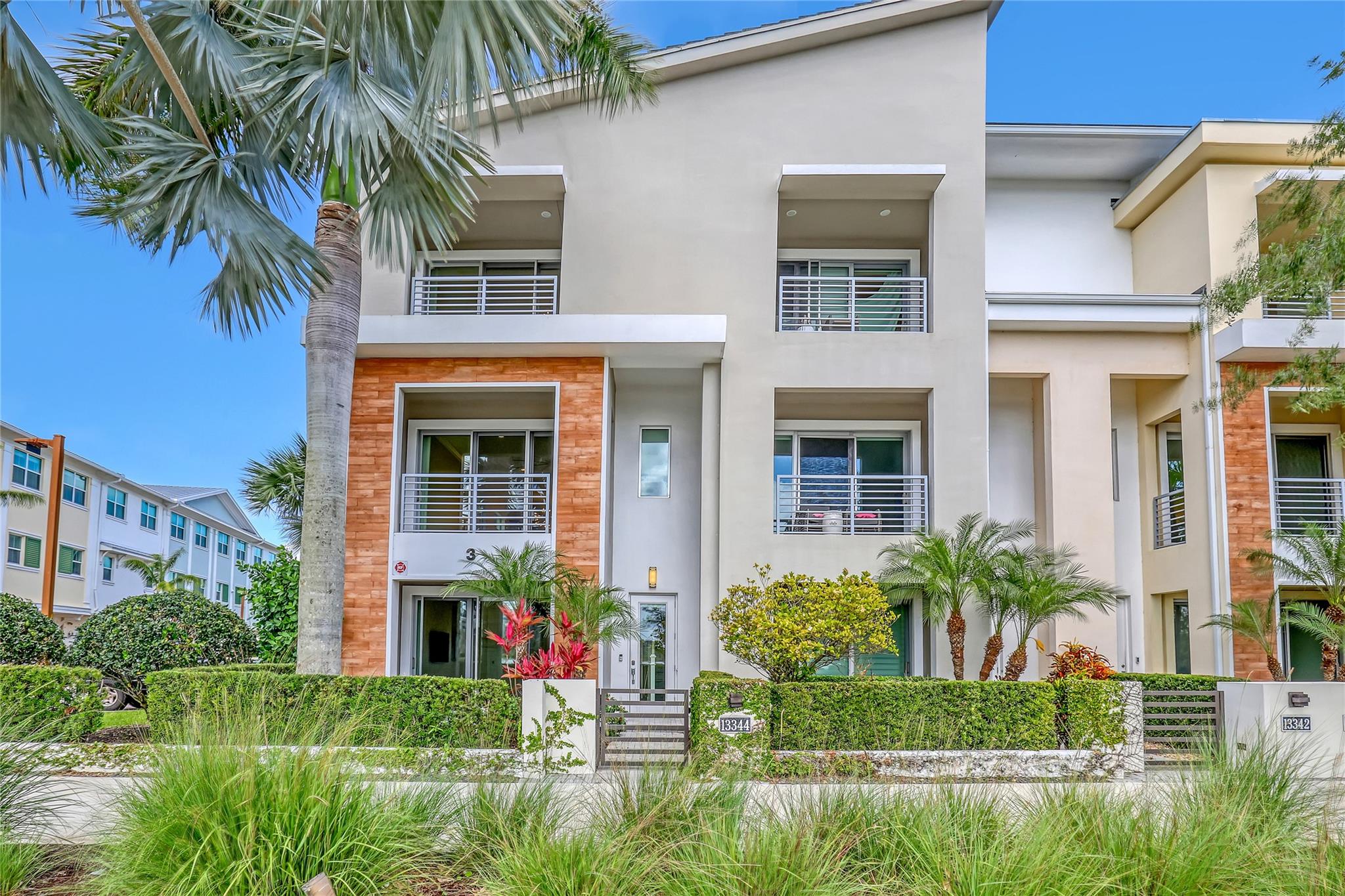 This exquisite, spacious corner unit townhouse (2750 sq ft) is conveniently located within walking distance of the Alton clubhouse, featuring a resort-style pool with cabanas, and other amenities. This tri-level residence is partially furnished and boasts lake views. The first floor includes a den/office, a half bath, and a walk-out patio. The second floor is the main living area, offering an open-concept kitchen, living, and dining spaces, and is complemented by a balcony with lake views. The kitchen has an oversized large island, quartz countertops, stainless steel appliances, and tile flooring. The third floor comprises three bedrooms and the master suite features a balcony with lake views, a luxurious ensuite bathroom, and spacious closet.
The 2-car garage is equipped to charge EVs. This absolutely stunning large corner unit townhouse is walking distance to Alton Clubhouse and resort style pool.  There is a brand-new AC unit as well as a brand-new Washer and Dryer.
This townhouse is partially furnished and has a large dining table with 10 chairs, matching buffet table, four bar stools and two TVs.