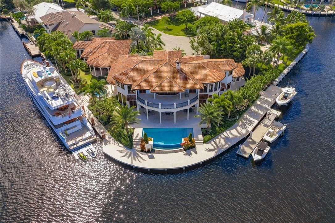 Stunning doesn’t begin to describe this estate in the exclusive Sunrise Key neighborhood. Sweeping river views await from a coveted point lot location. The main house nestled on a lot comprising nearly two-thirds of an acre with 355 feet of water frontage. High-end finishes, from marble floors to soaring ceilings & Floor-to-ceiling windows frame the views to perfection. Open floor plan is perfect for entertaining w/ amenities like temp-controlled wine cellar, media room &elevator. Meander to the separate guest house with 2 beds/2 baths, perfect  for staff. Soak in the sun from the infinity pool, central to two mega yacht docks ready to welcome your personal fleet.