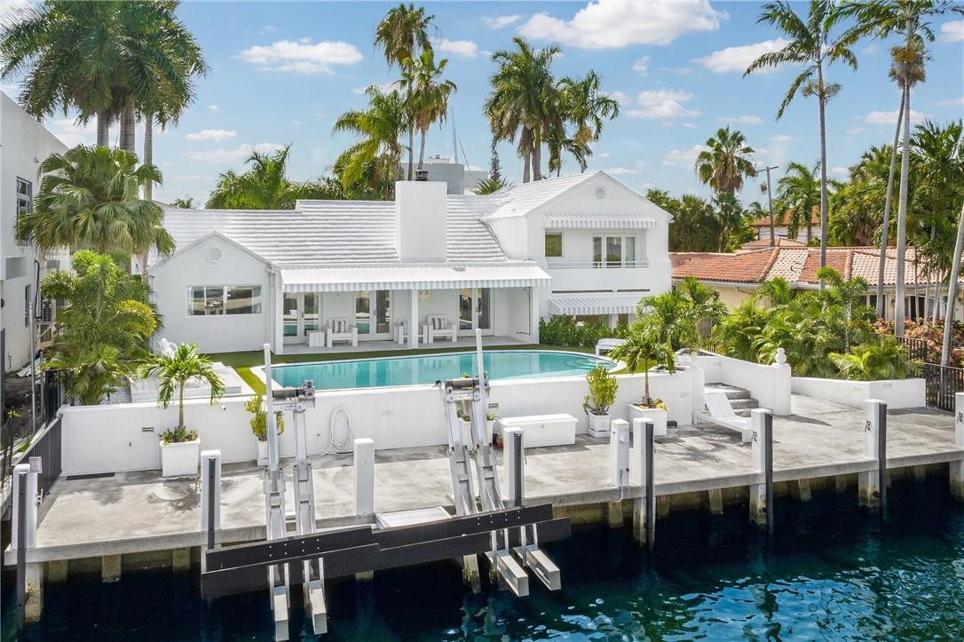 Immerse yourself in the epitome of waterfront living at this meticulously maintained waterfront estate located in the prestigious Las Olas Isles! This furnished, turnkey residence offers 3 bedrooms, 2.5 baths, & 75' of WF. Upgraded wood floors throughout exude elegance, while the large primary suite impresses with dual walk-in closets and a luxurious freestanding tub. The lush tropical landscaping envelops the property, creating a private oasis. Enjoy endless water views from guest bedroom's private terrace. The outdoor space boasts a large covered patio, oversized pool, and upper deck overlooking the new concrete dock with an electric 27K LB boat lift. Large driveway with tiled 2 car garage. Just a short walk to the best shopping, dinning, & nightlife that Fort Lauderdale has to offer!